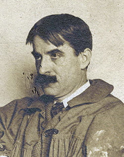 a black and white photo of a man with a mustache.