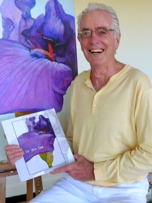 a man holding a picture of a purple flower.