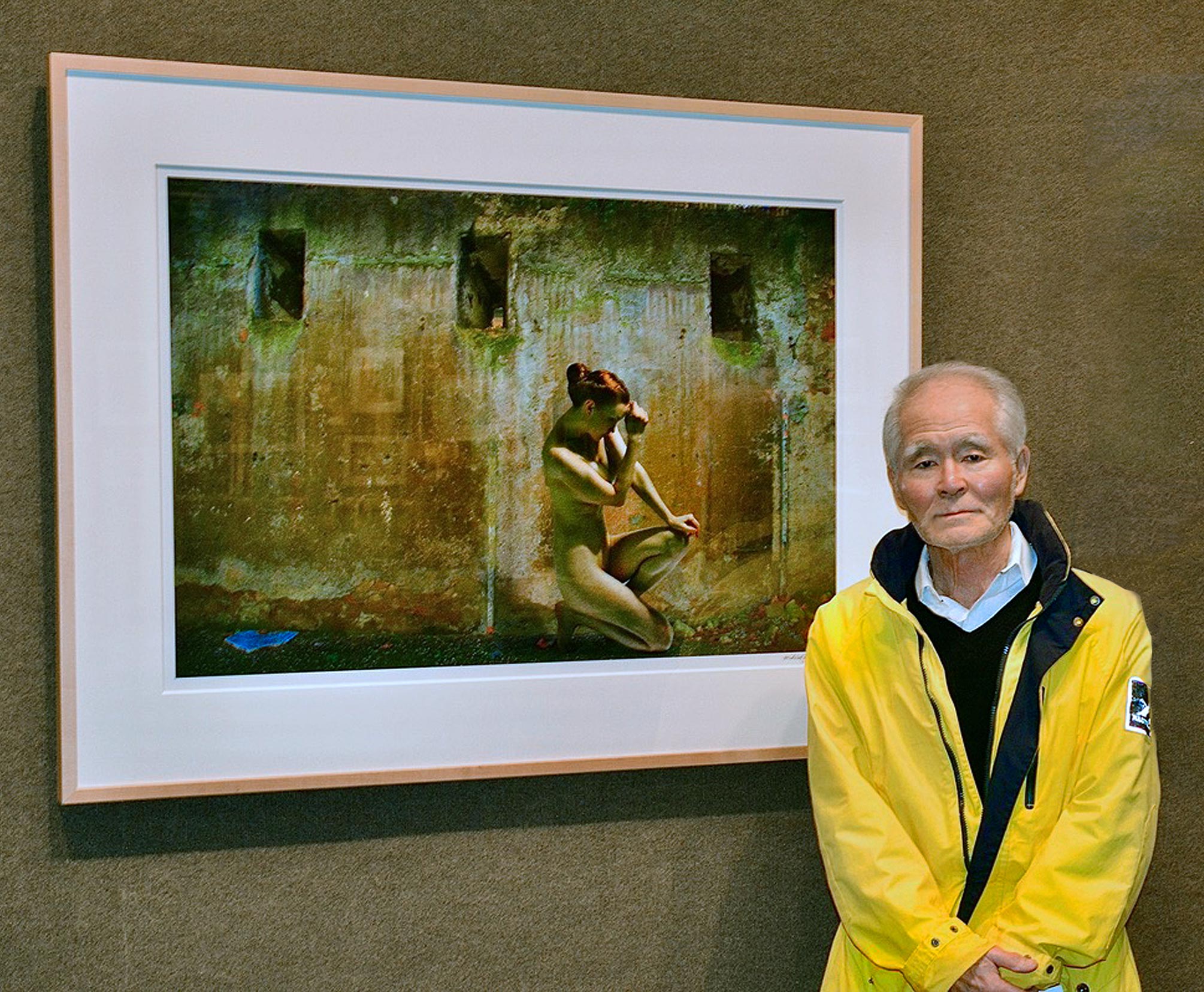 a man standing in front of a picture of a dog.
