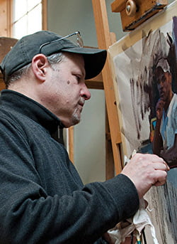 a man painting a picture on a canvas.