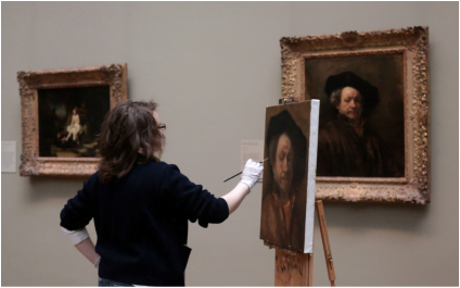a woman is painting a portrait of a man.