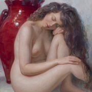Nude woman sitting on the ground with her head leaning on her hand on her knee next to a huge red vase.