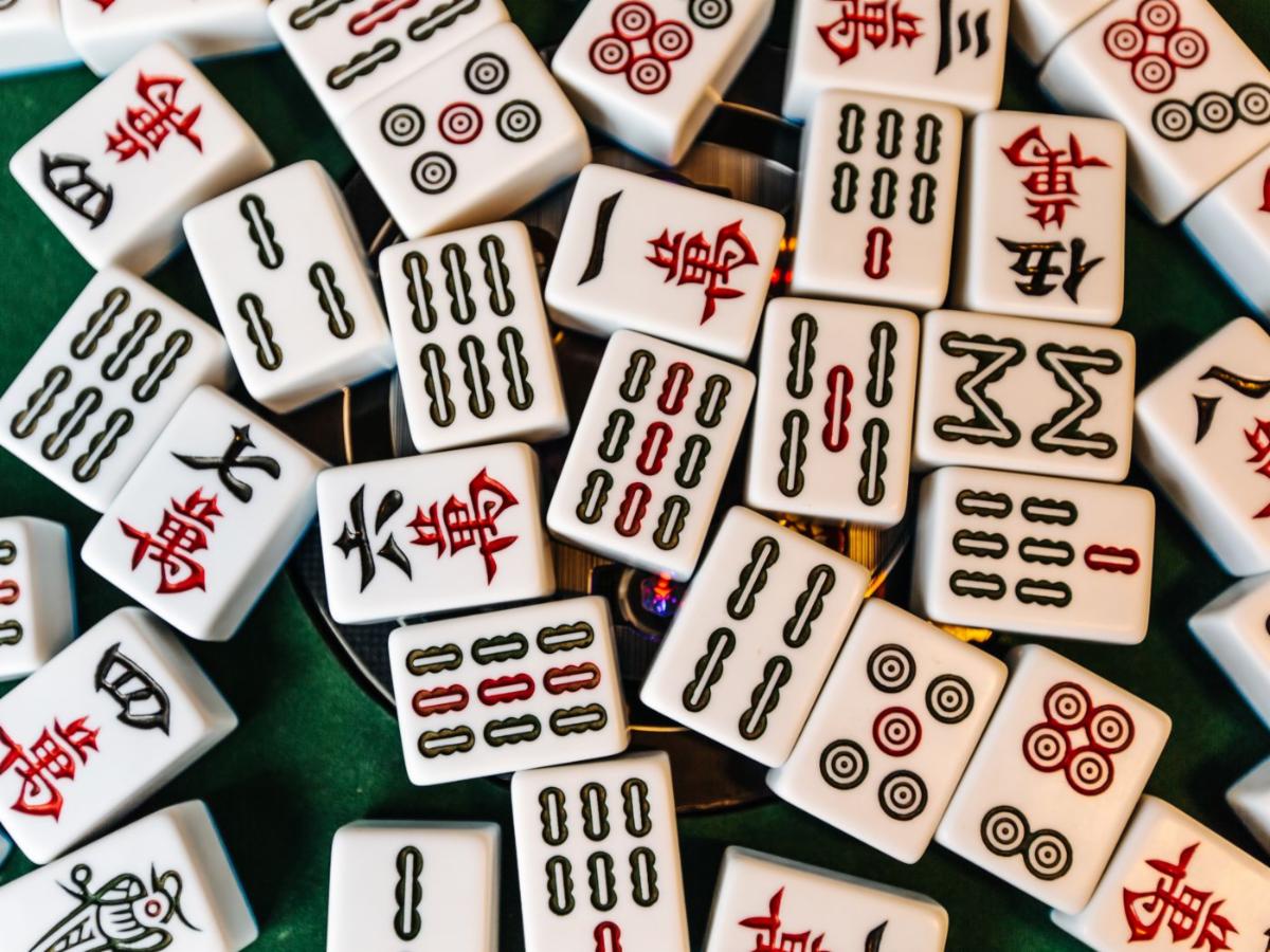 Mahjong tiles scattered across a green table