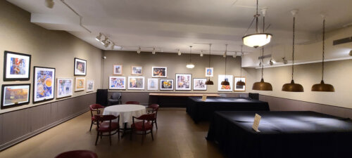 Salmagundi's Rockwell gallery, with artworks on the wall and covered pool tables