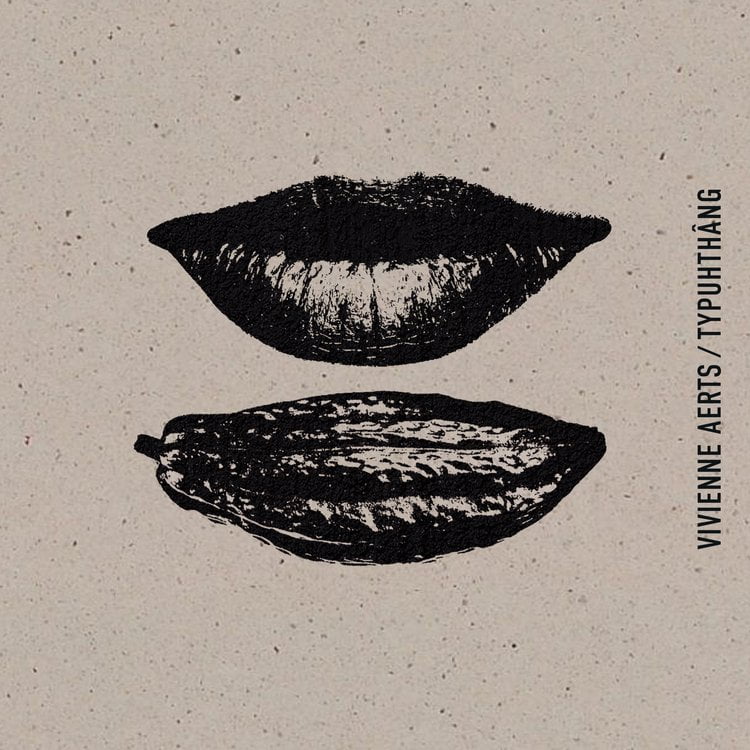 What appears to be a black and white print of a set of lips over a cocoa bean that is roughly the same size and shape as the lips. Text on the side reads "Vivienne Aerts/Typuhthâng"