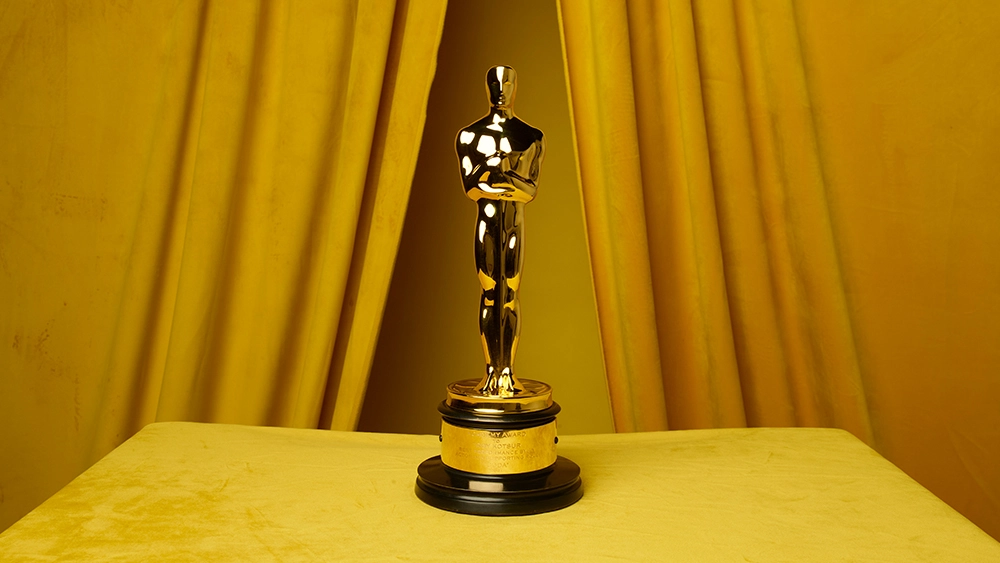 Academy award with golden curtains behind.