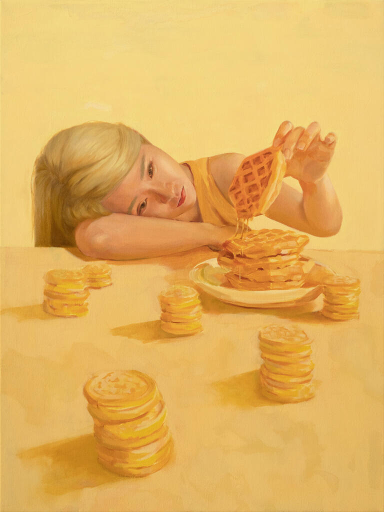 A blonde child rests her head in the crux of her arm, on a table. Unenthused, she lifts up a syrupy waffle from its stack on her plate. Everywhere else on the table are stacks of miniature pancakes.