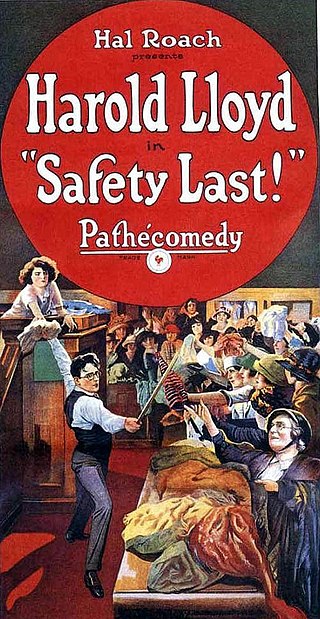 "Safety Last" poster. A horde of people rush a counter with fabrics, behind which is a man brandishing a pole and a woman holding something out for him.