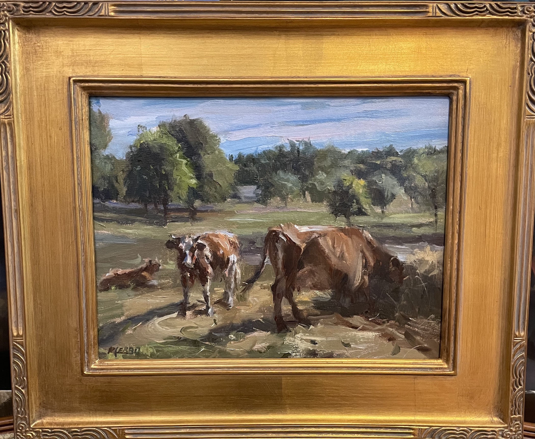 "Out to Pasture" in a golden frame with textured designs on the inner and outer edges and in the corners.