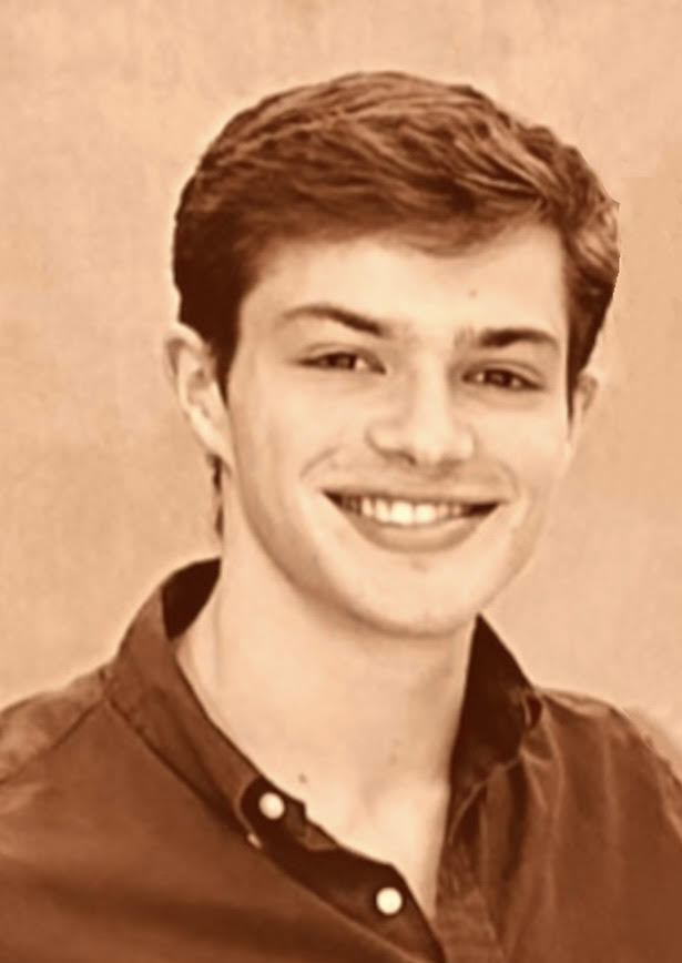 A sepia-colored photo of a young man smiling for the camera in a collared shirt.