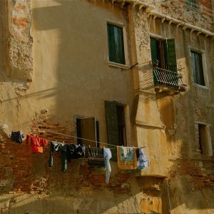 A photograph of a building with clothes hanging on a line.