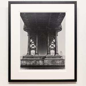 A photo of the Manhattan bridge pier with a thin black frame.