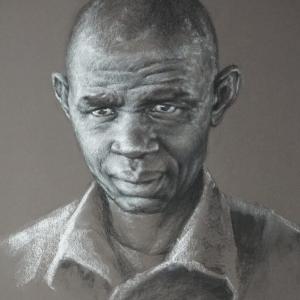 A charcoal drawing of a man with a bald head.