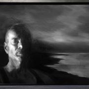 A black and white painting of a man in front of the ocean.