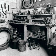 A black and white photo of a garage with various tools.