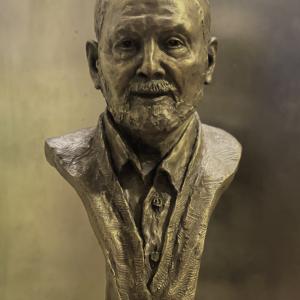 A bronze bust of a man with a beard.